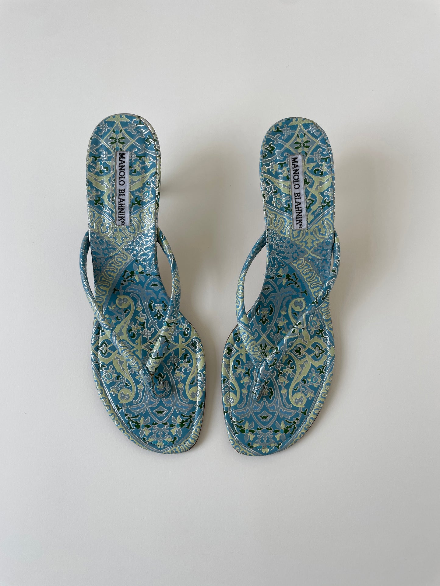 Vintage Manolo Blahnik baby blue metallic paisley thong kitten heels.