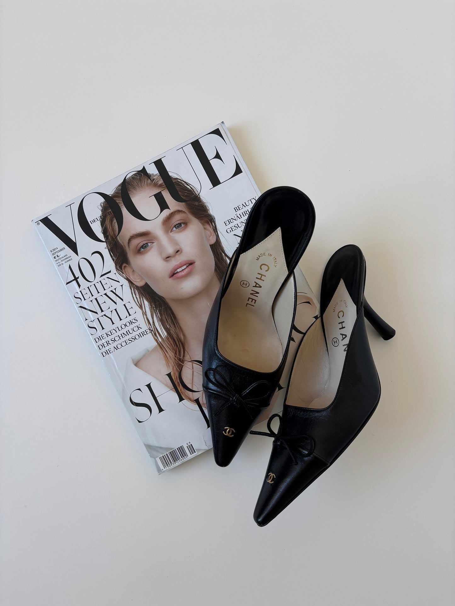 Vintage iconic Chanel 2000s pointed black CC kitten mules with tiny CC golden logo at the top and the heels.