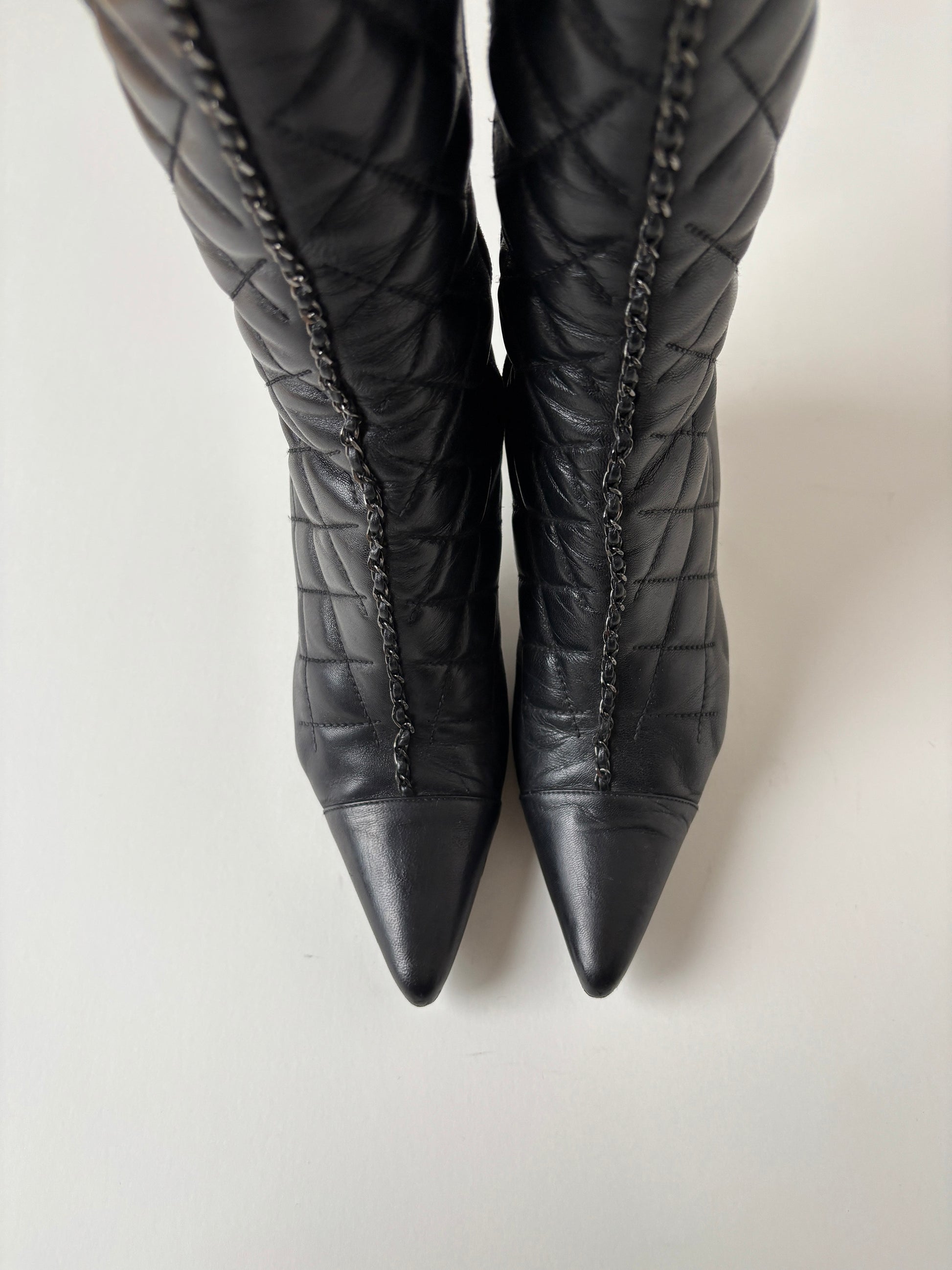 Vintage Chanel by Karl Lagerfeld 2000s black quilted boots with chain element.