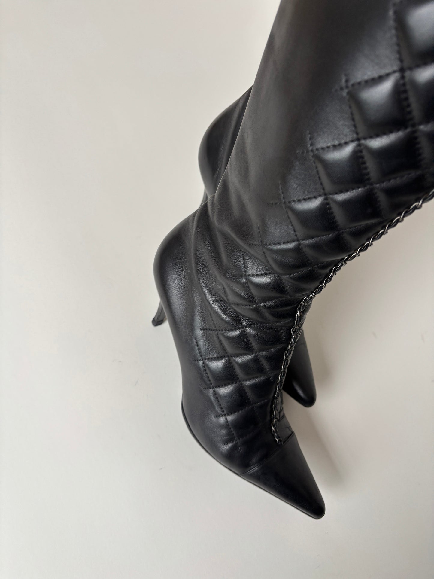 Vintage Chanel by Karl Lagerfeld 2000s black quilted boots with chain element.