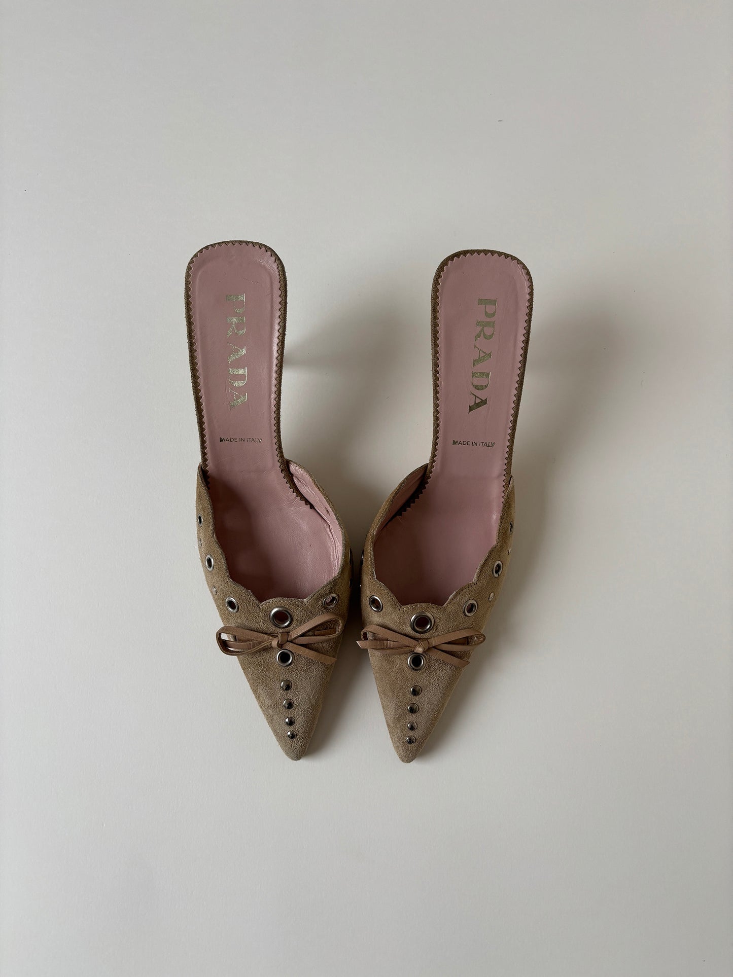 Iconic vintage Prada 2000s suede eyelet bow mules with cute details.