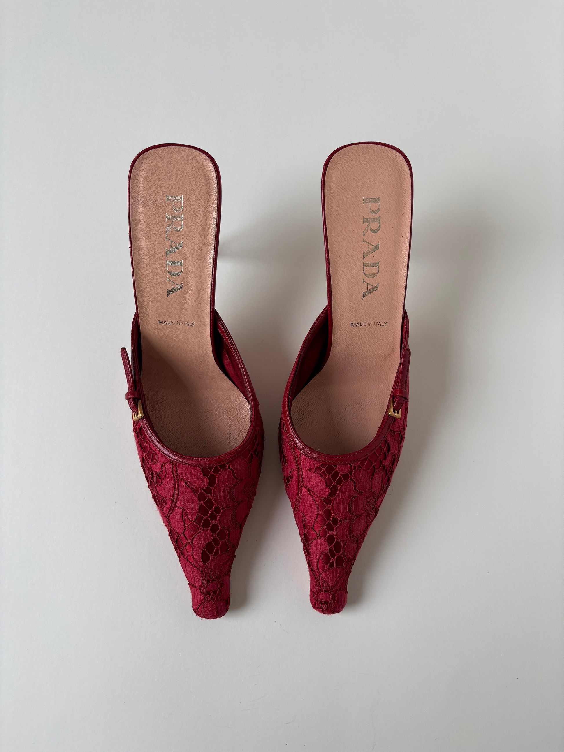 Vintage Prada 2000s red lace kitten heel mules with silver buckle details. 