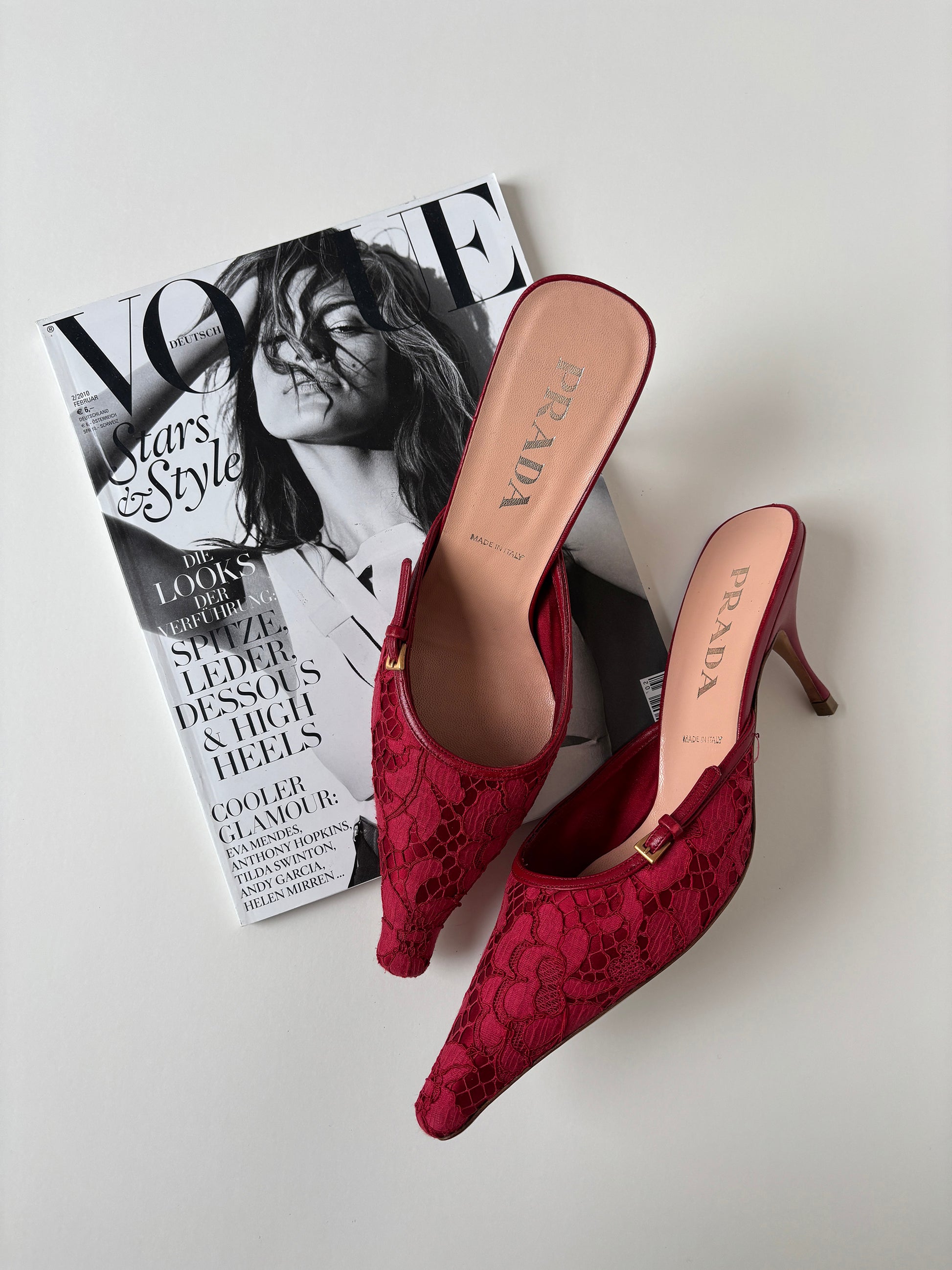 Vintage Prada 2000s red lace kitten heel mules with silver buckle details. 