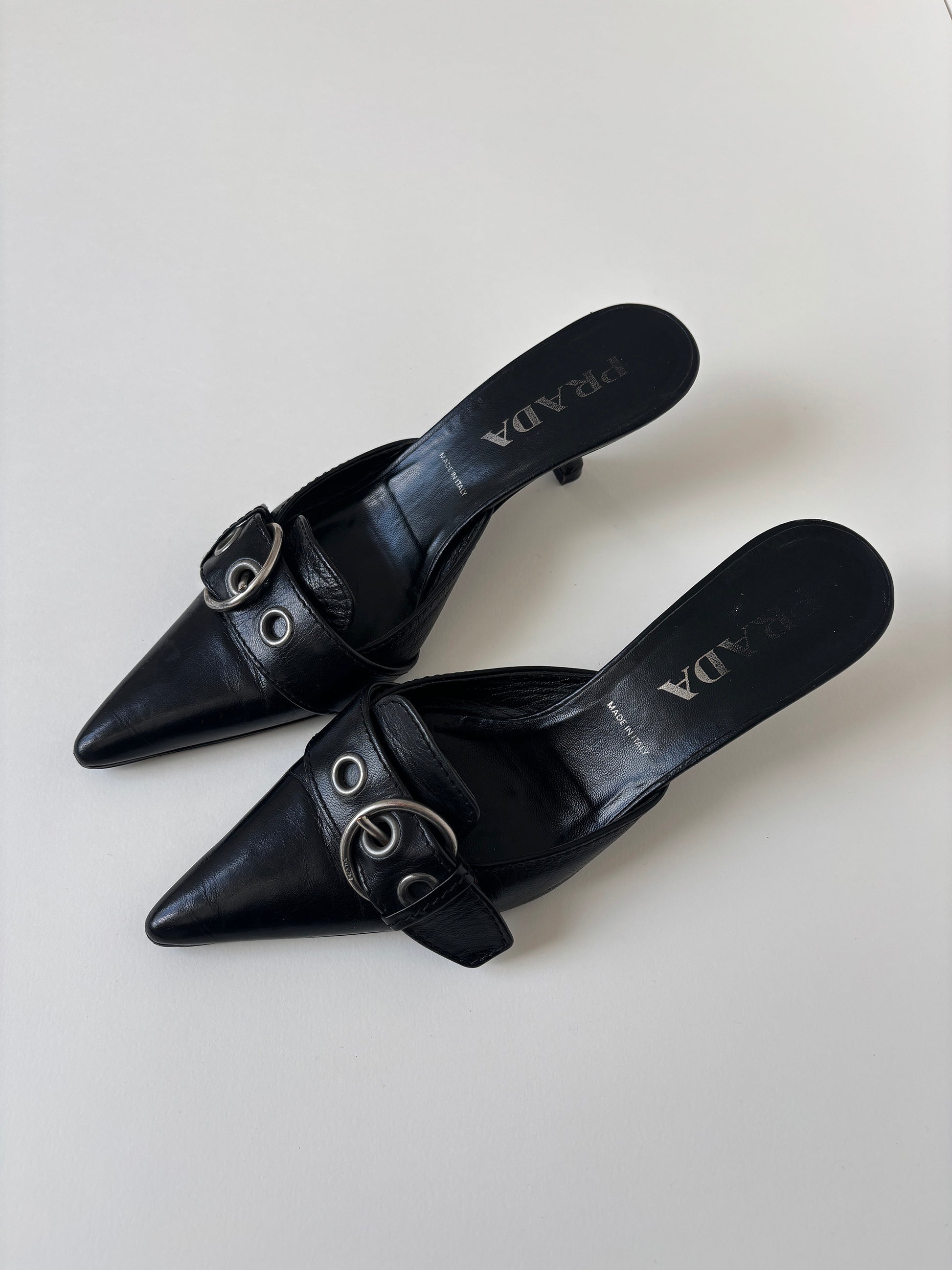 Vintage Prada S/S 2002 black kitten heel mules with silver buckle details. 