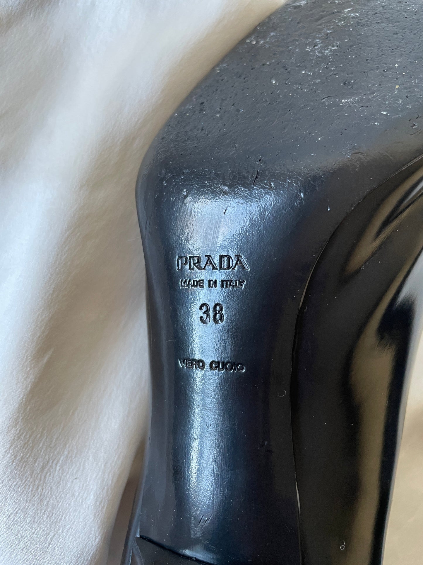 Prada patent leather metal logo heels