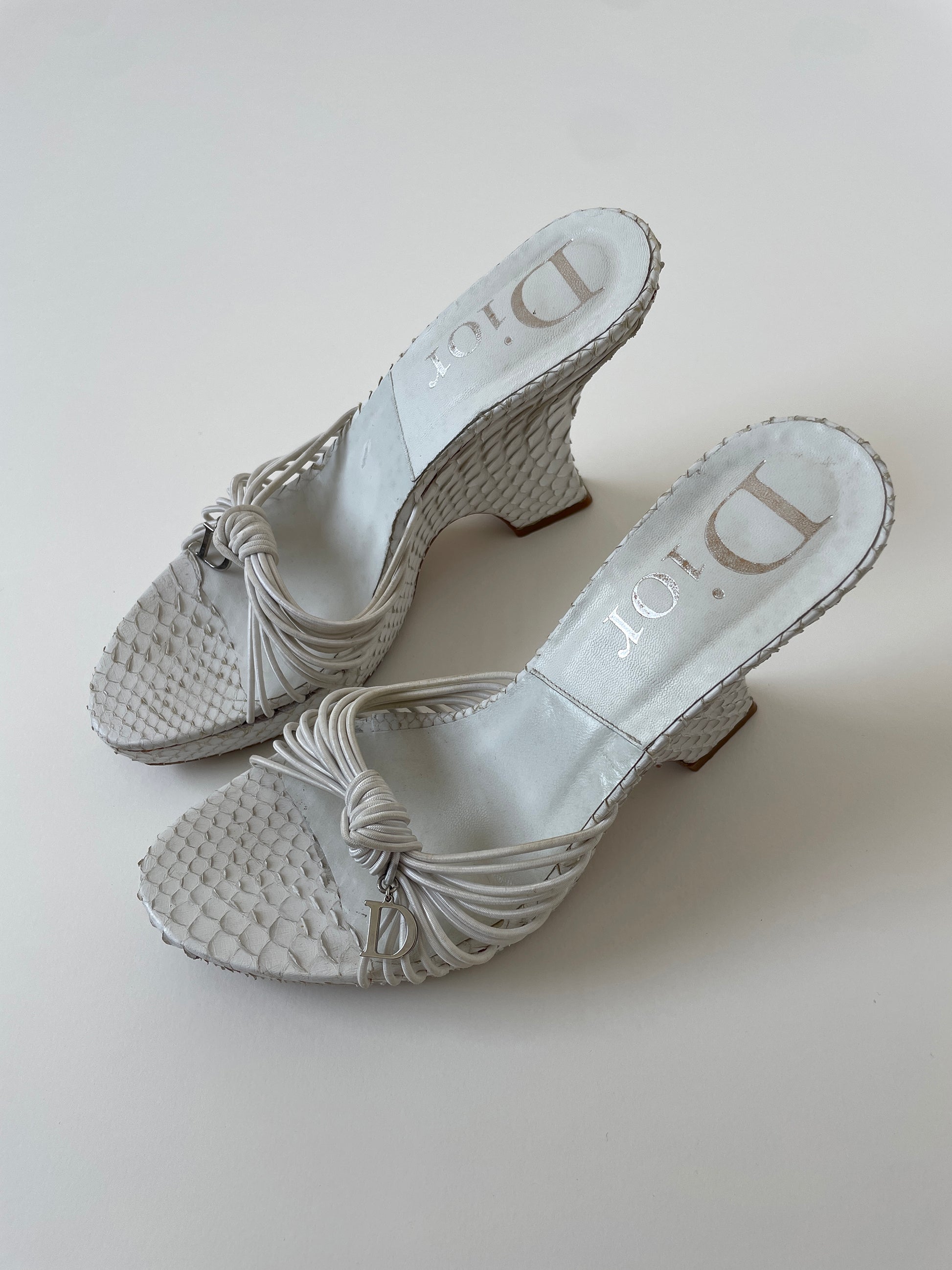 Vintage Christian Dior by John Galliano 2003 white python wedge platform heels with silver D-charms.
