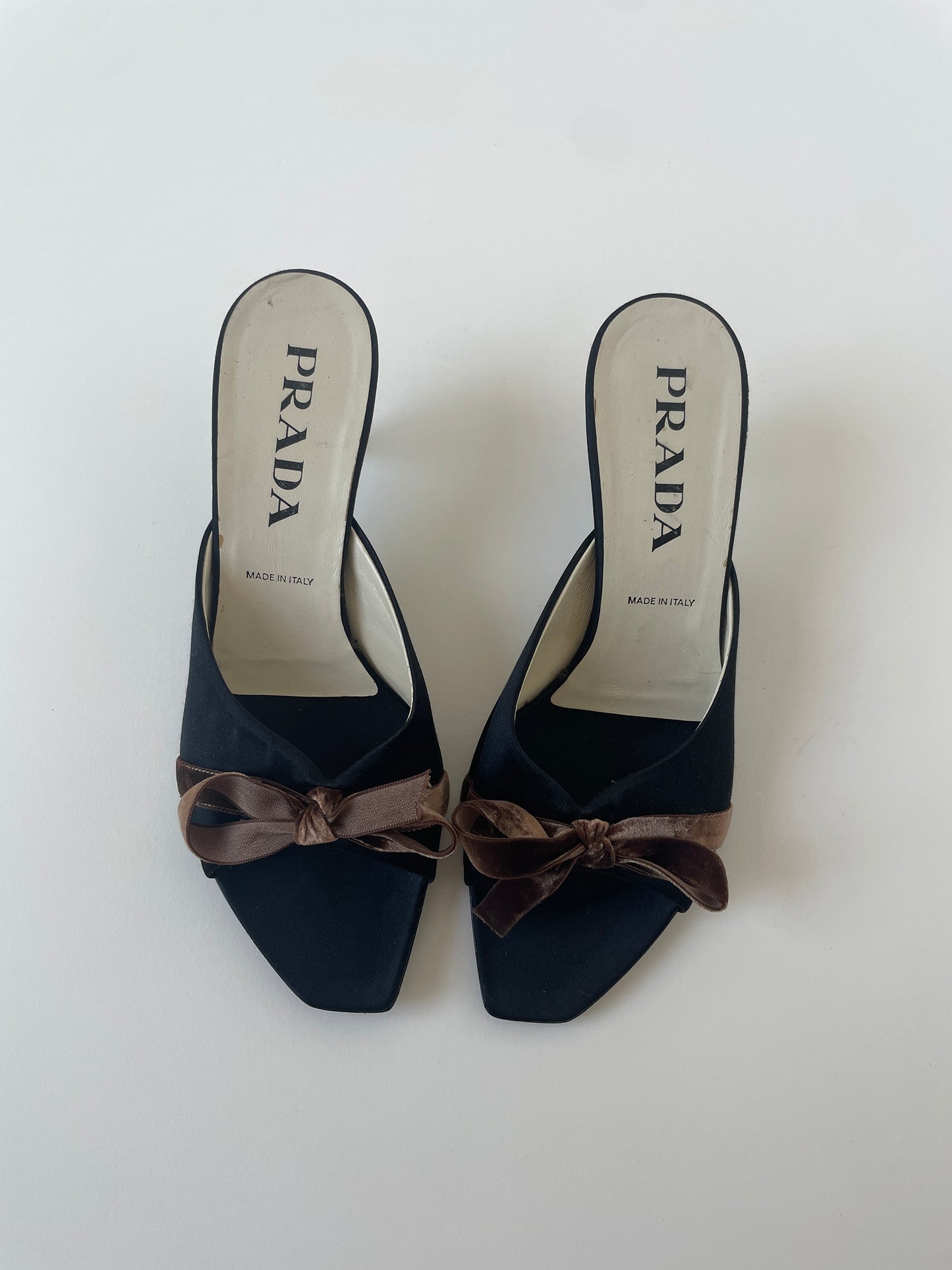 Vintage Prada 1990s black silk kitten heels with cute brown bow details.