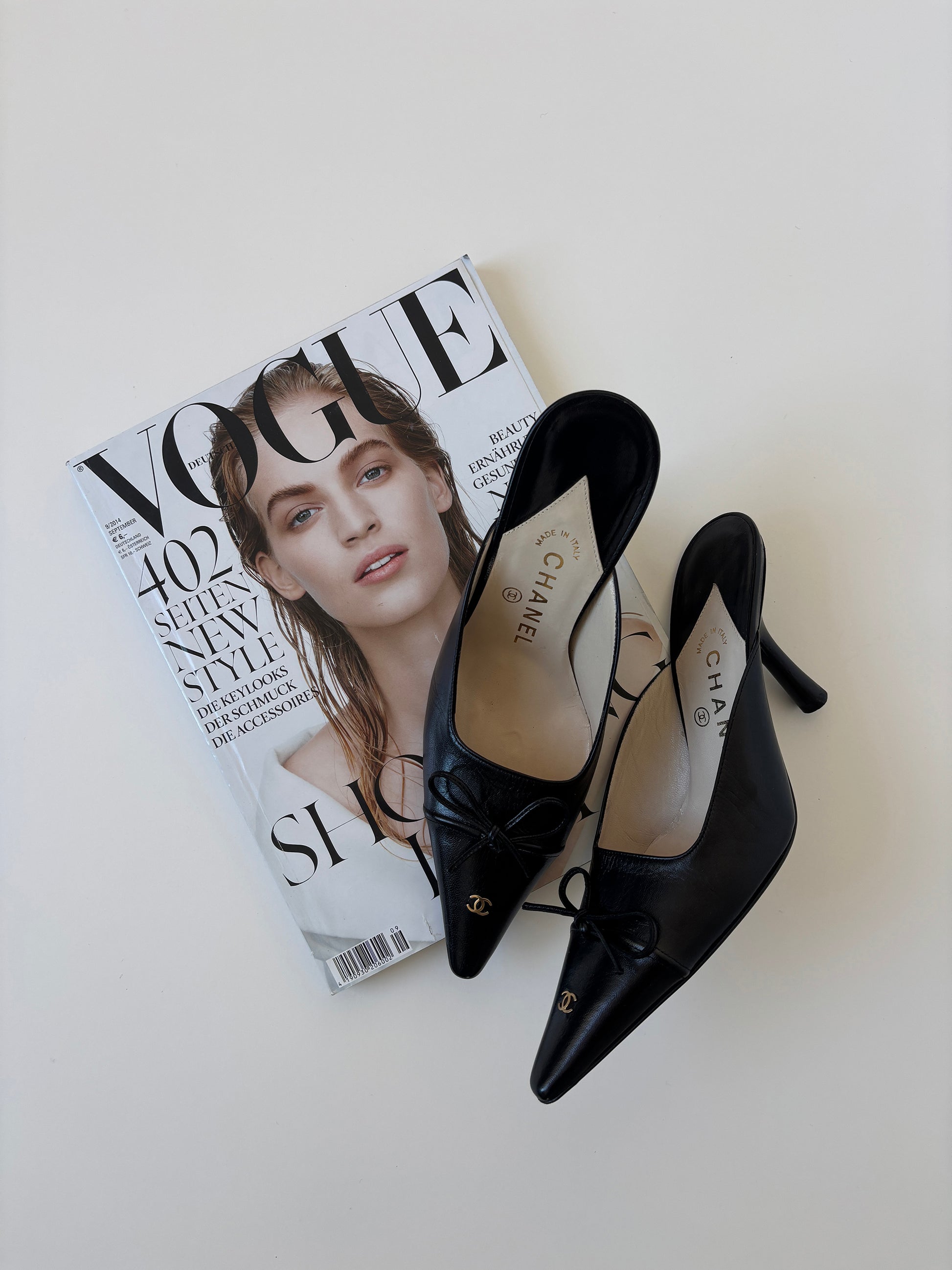 Vintage iconic Chanel 2000s pointed black CC kitten mules with tiny CC golden logo at the top and the heels.