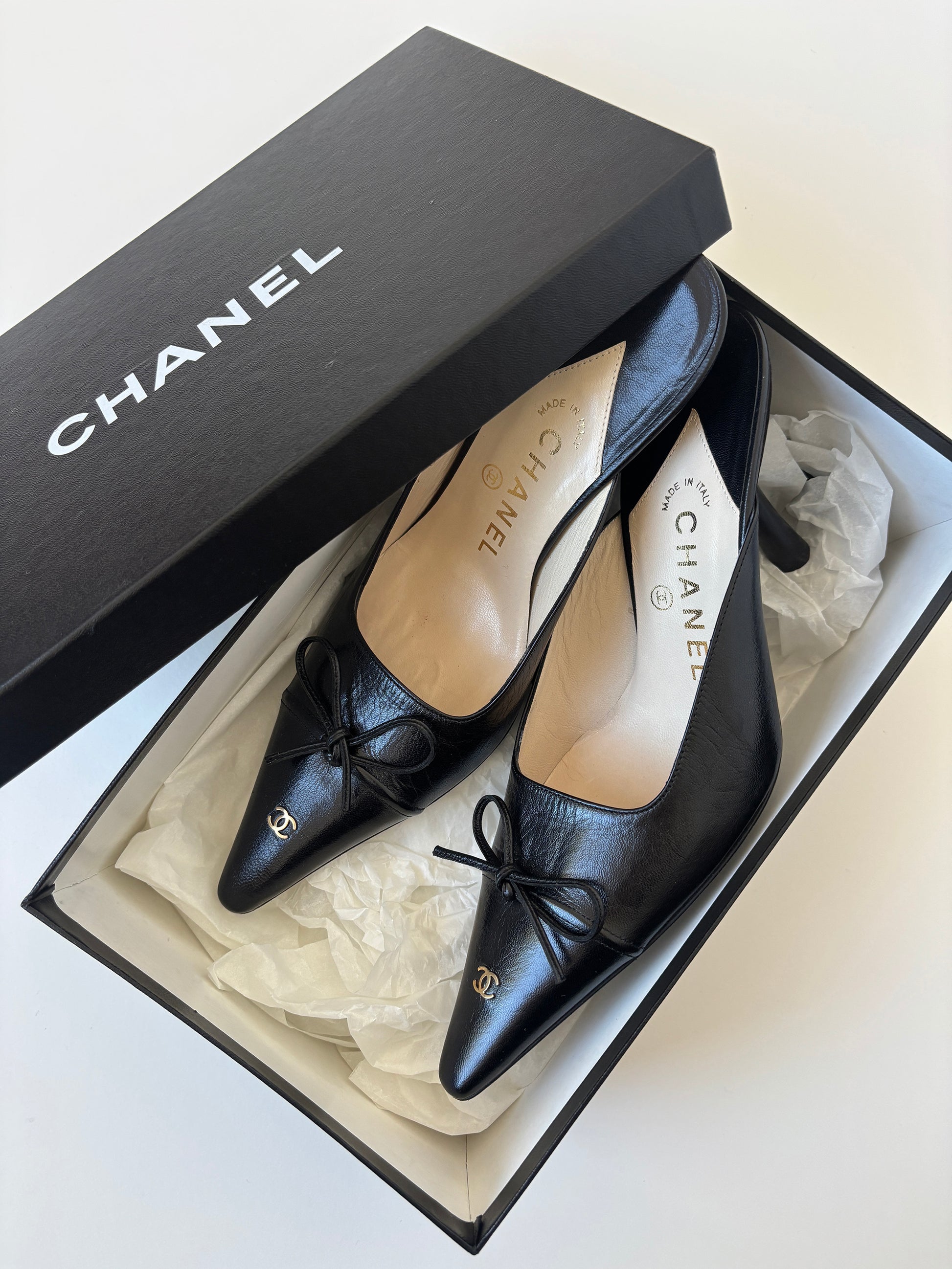 Vintage iconic Chanel 2000s pointed black CC kitten mules with tiny CC golden logo at the top and the heels.