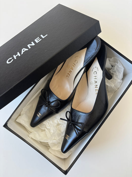 Vintage iconic Chanel 2000s pointed black CC kitten mules with tiny CC golden logo at the top and the heels.