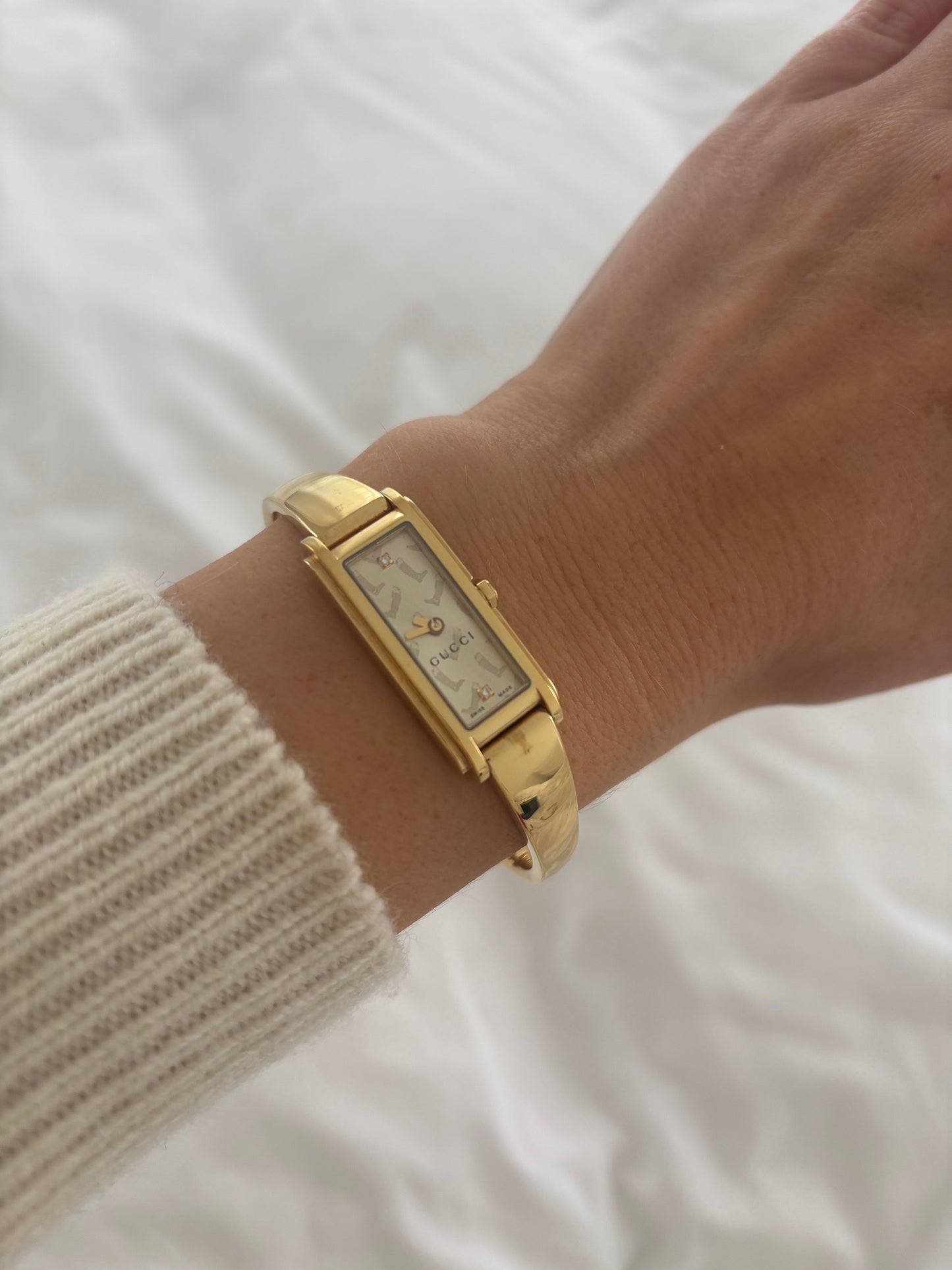 Vintage Gucci by Tom Ford 2000s 1500L 18K gold plated bangle watch with light golden dial with mini diamonds, a rider boots print and horsebit clasp
