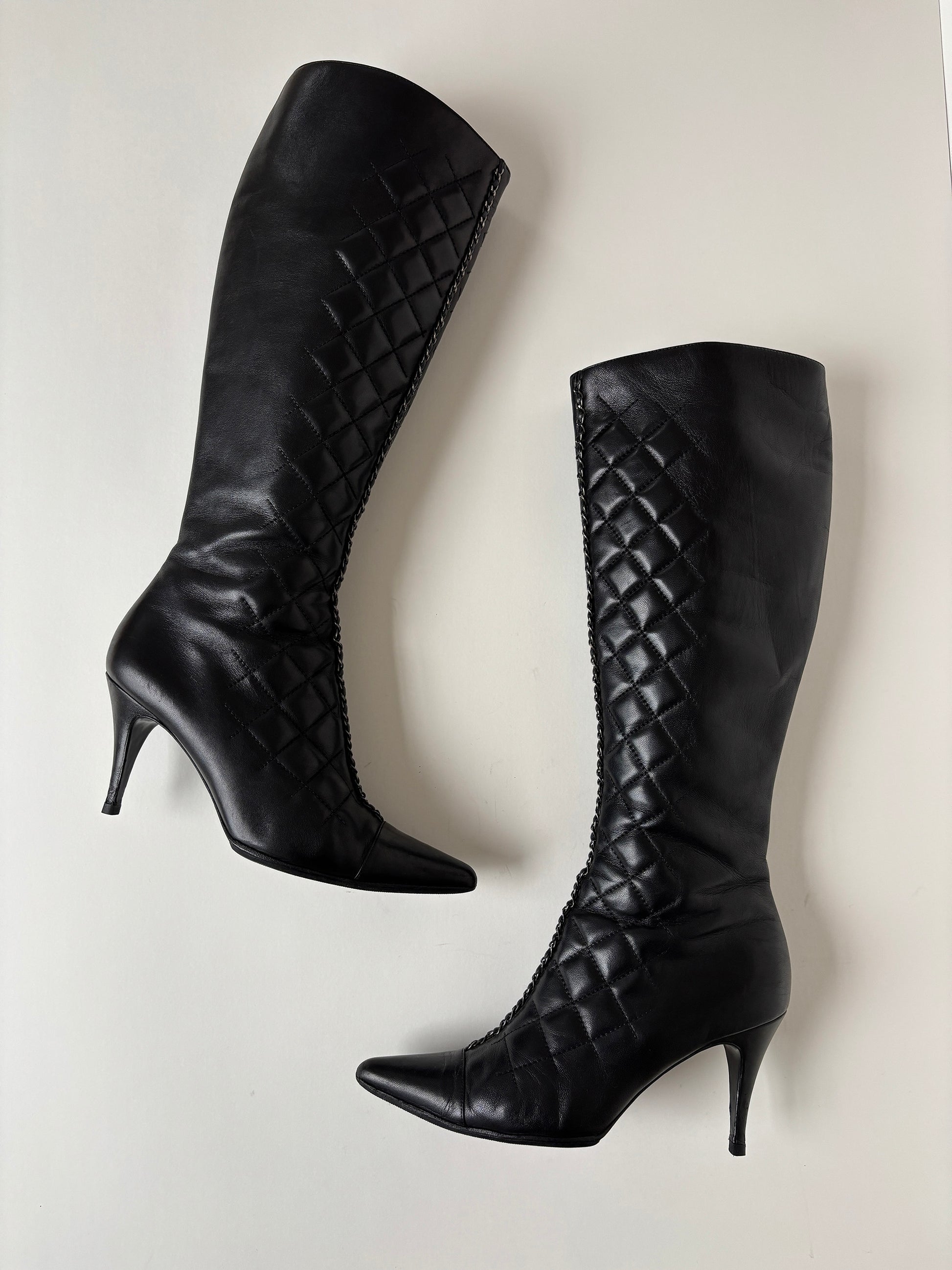 Vintage Chanel by Karl Lagerfeld 2000s black quilted boots with chain element.