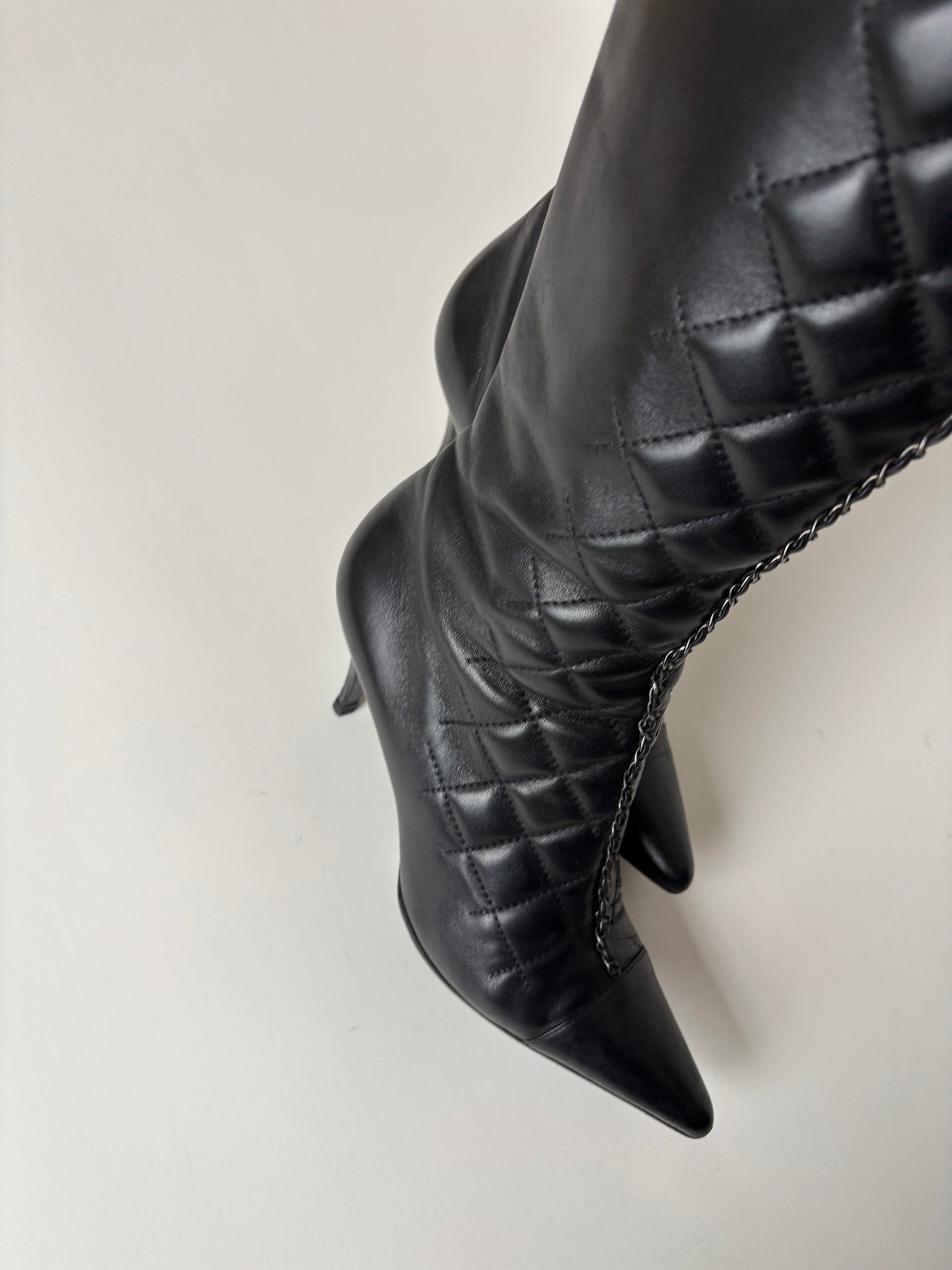 Vintage Chanel by Karl Lagerfeld 2000s black quilted boots with chain element.