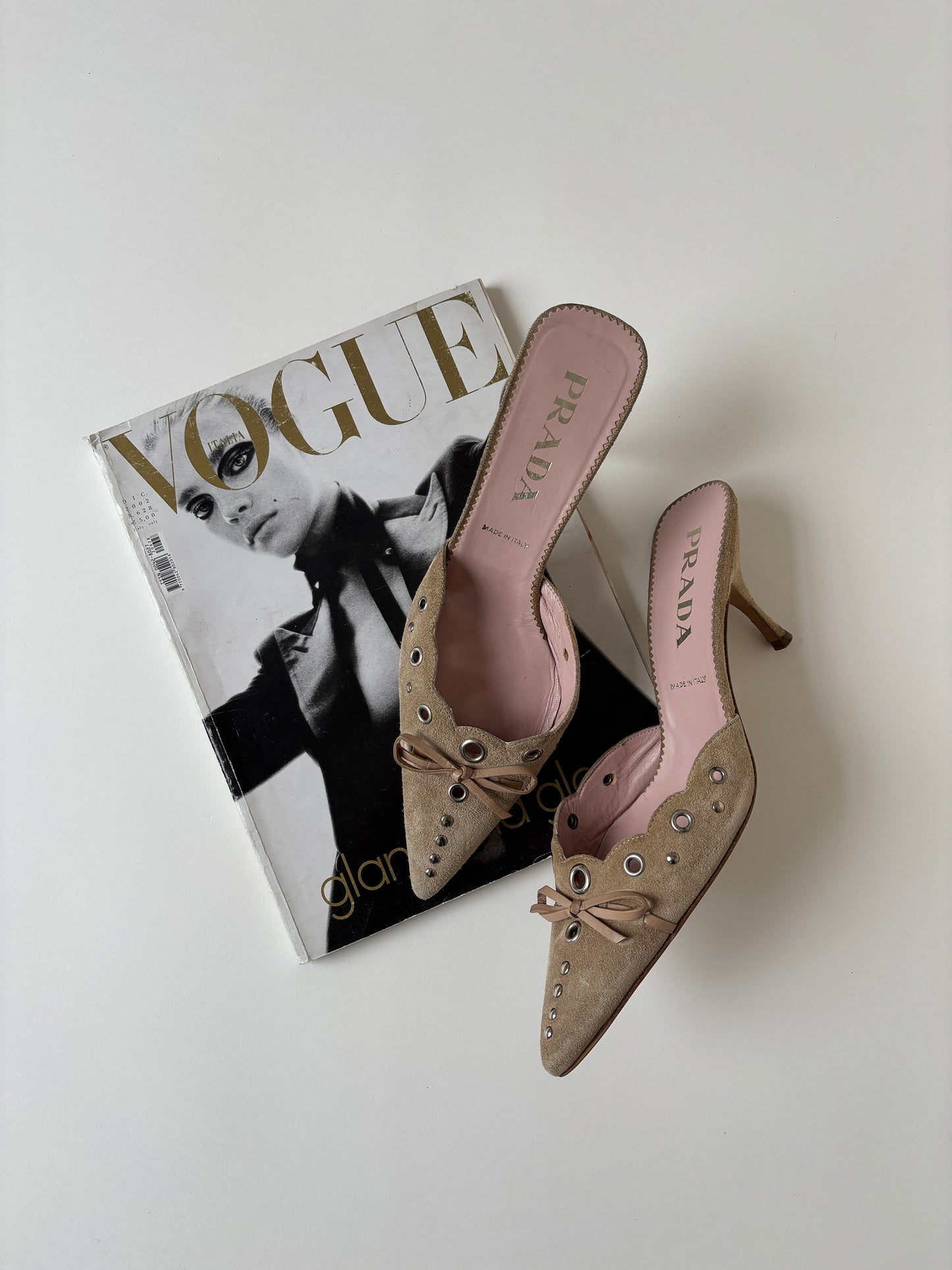 Iconic vintage Prada 2000s suede eyelet bow mules with cute details.