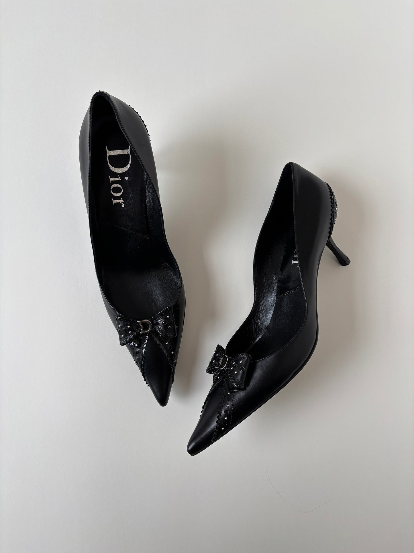 Vintage Christian Dior by John Galliano 2000s black D Trick bow kitten heels with cute mini logo and dainty eyelets.