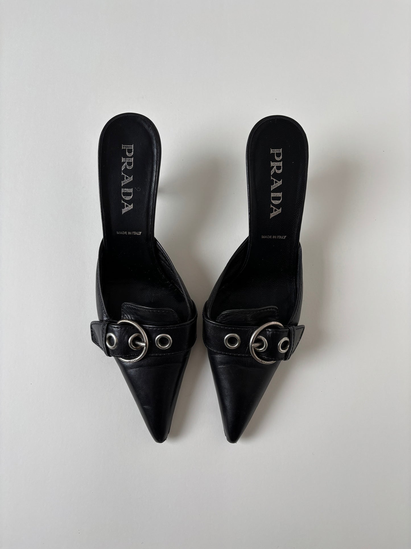 Vintage Prada S/S 2002 black kitten heel mules with silver buckle details.&nbsp;

