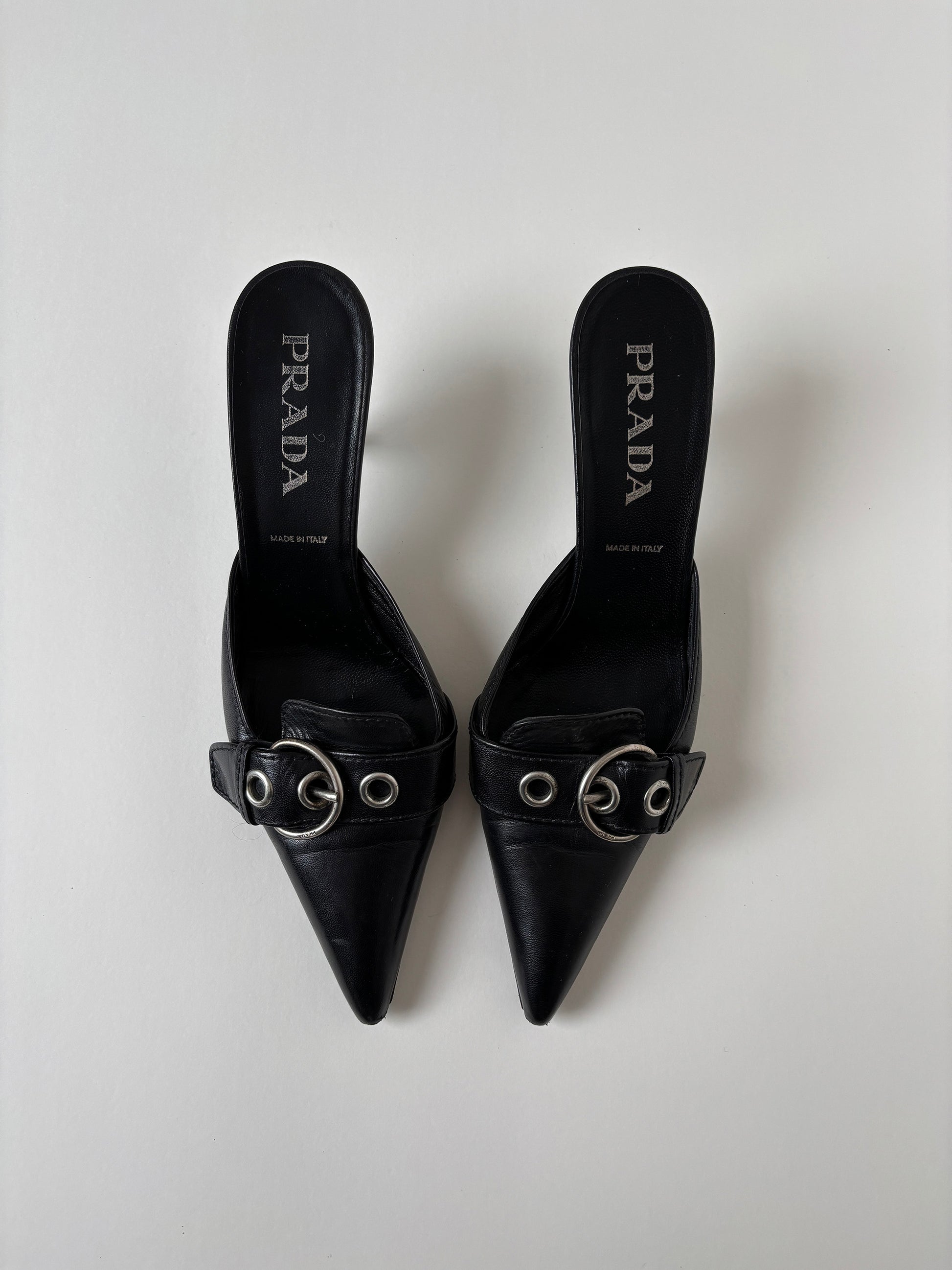 Vintage Prada S/S 2002 black kitten heel mules with silver buckle details.&nbsp;
