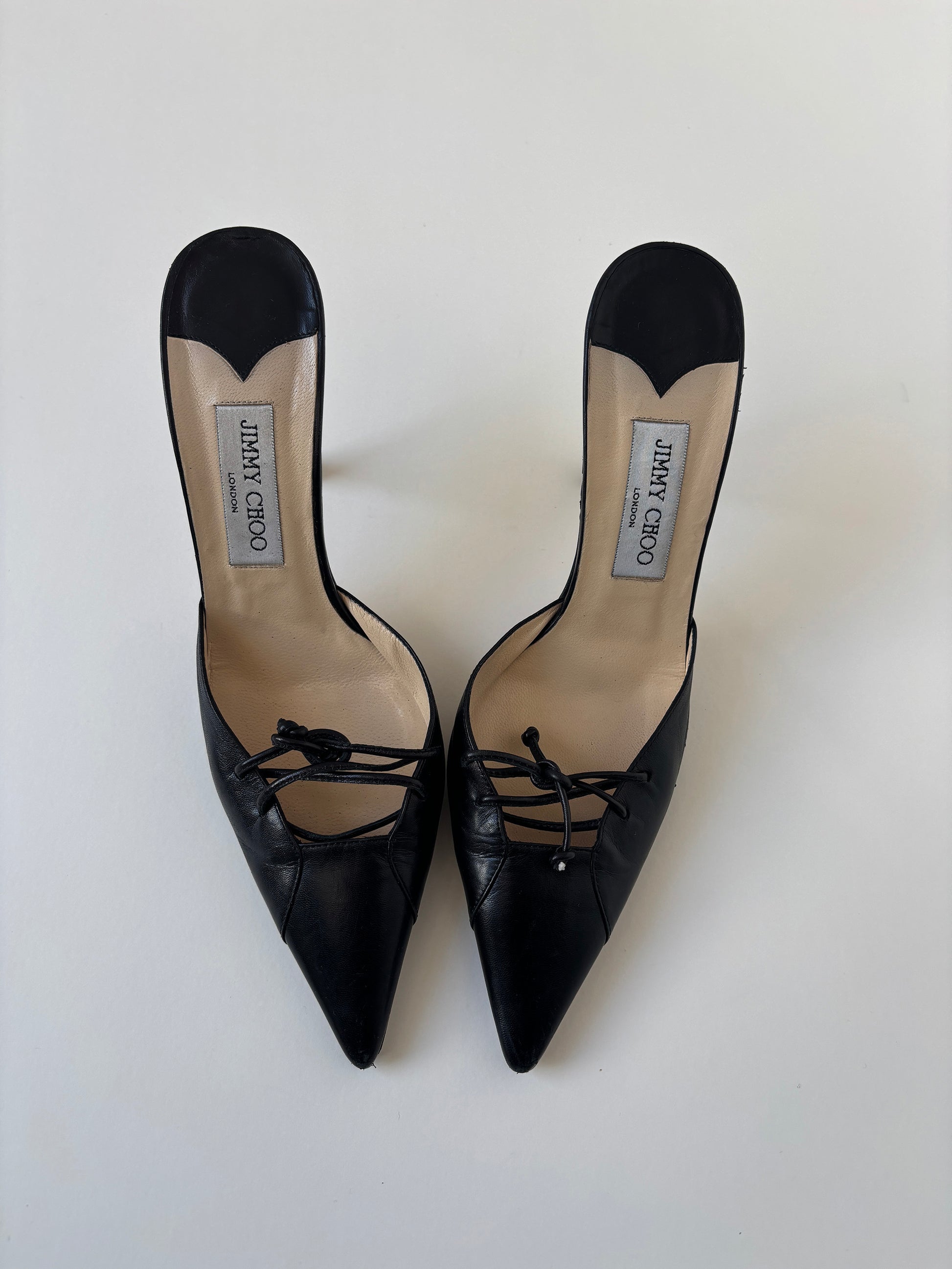 Vintage Jimmy Choo 2000s black mules with lace bow details.