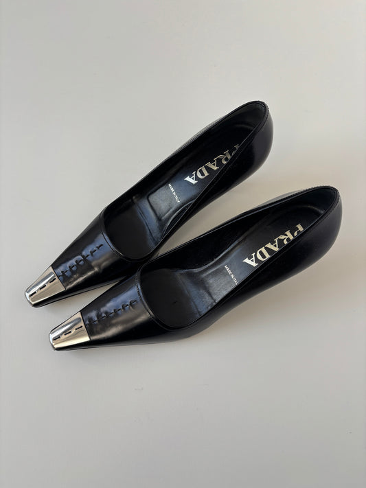 Vintage Prada 2000s black kitten heels with silver metal cap details.