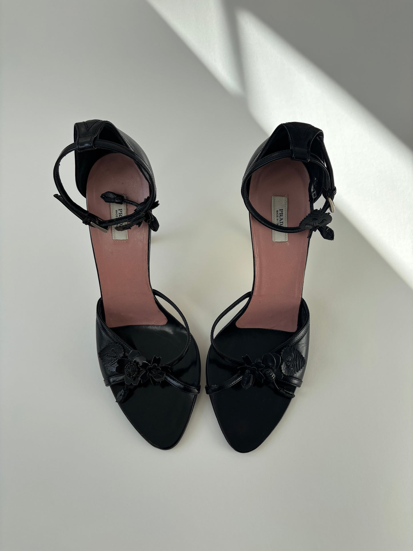 Vintage Prada black heels with cute floral details and ankle strap.