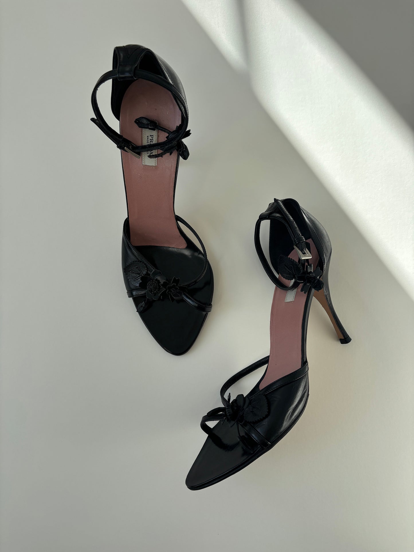 Vintage Prada black heels with cute floral details and ankle strap.