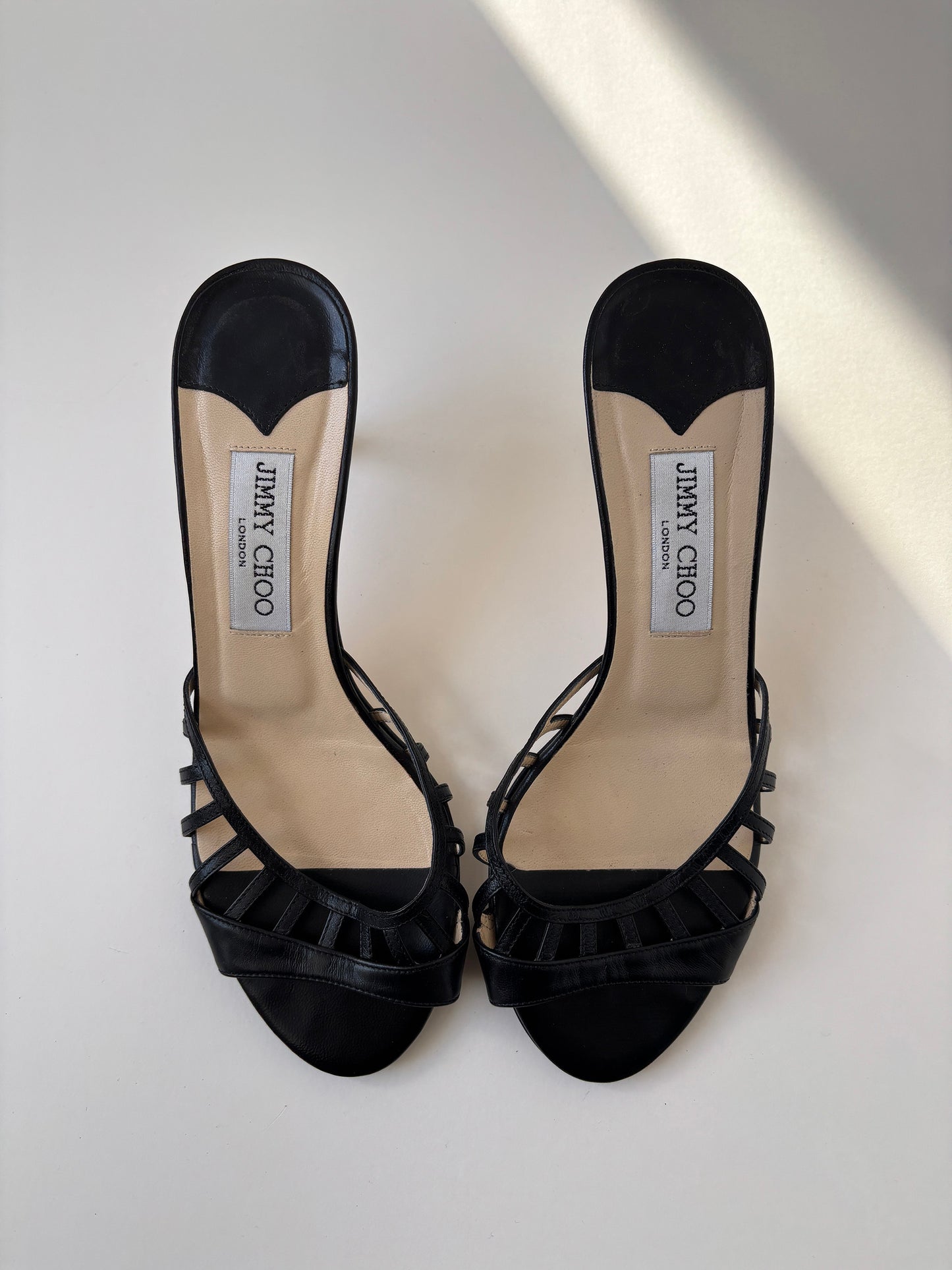 Vintage Jimmy Choo 2000s black kitten heels with cute cutouts.